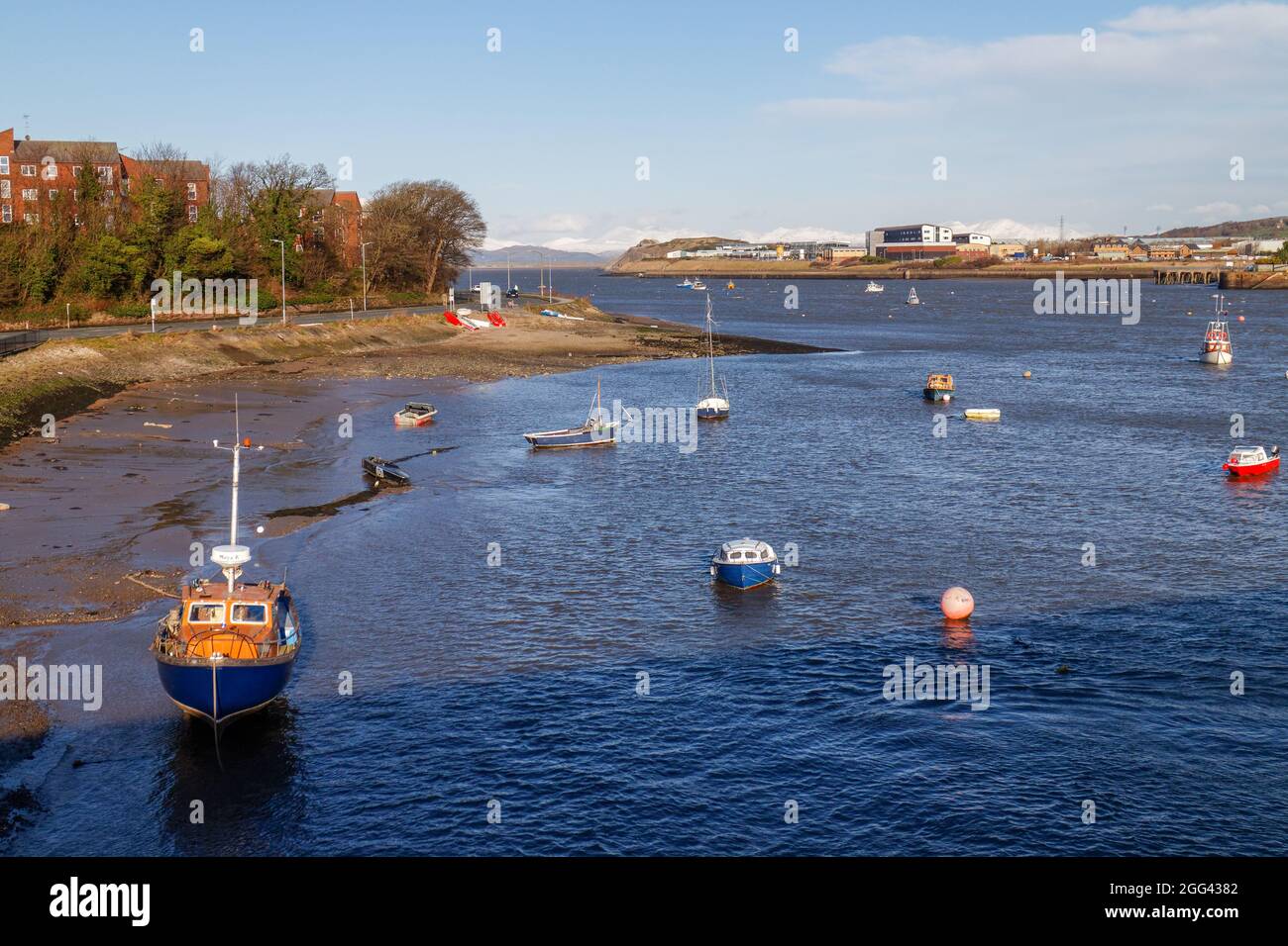 Yachts and boats in the Walney Channel and the waterfront of Barrow-in-Furness seen from Walney Island Stock Photo