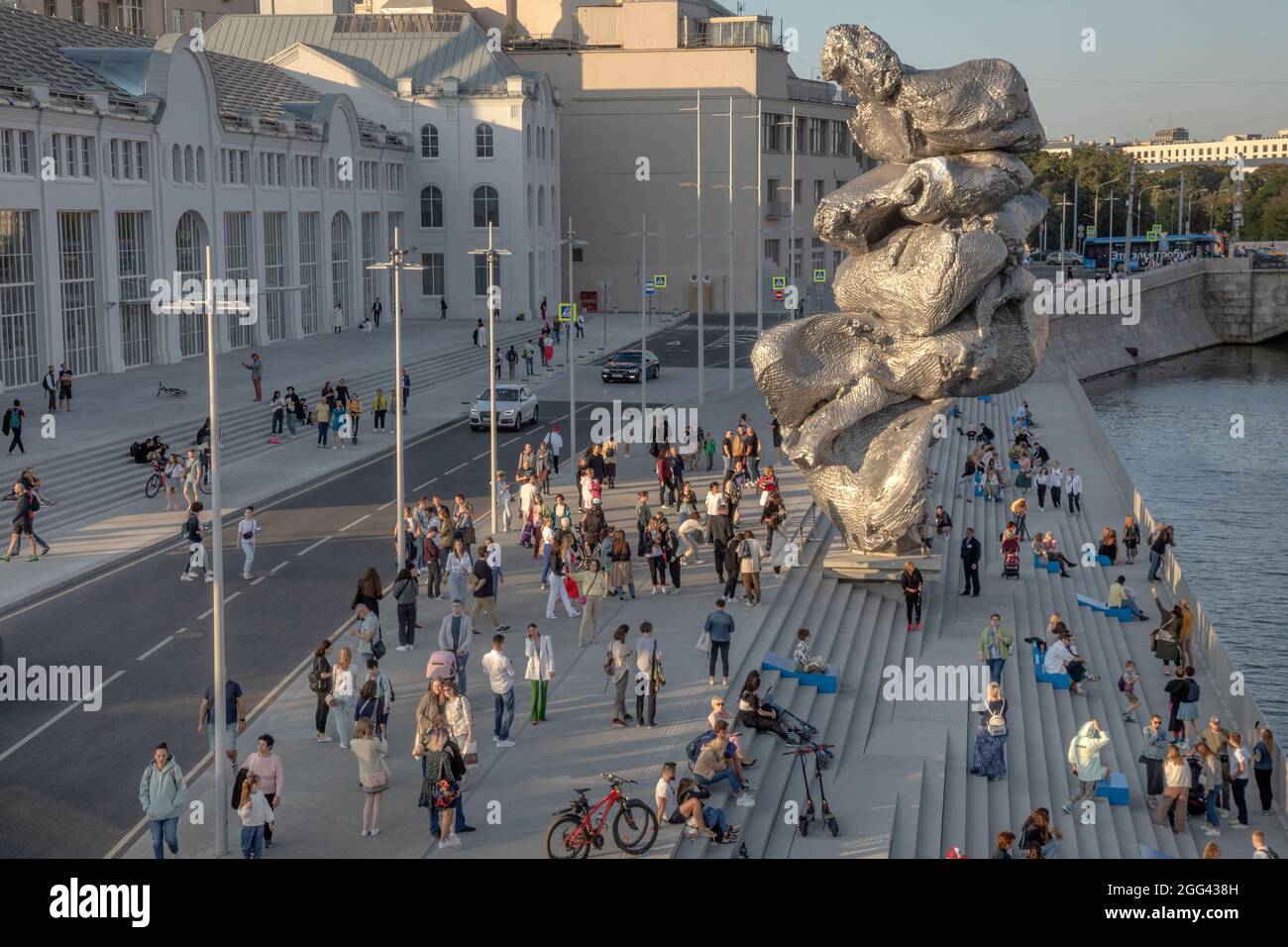 Moscow, Russia. 28th of August, 2021 People walk along the Bolotnaya Embankment on the background of the sculpture "Big clay No. 4" by Swiss artist Urs Fischer in the center of Moscow city, Russia Stock Photo