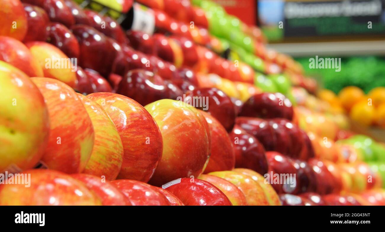 Fresh apples in bountiful produce display in farmers market Stock Photo
