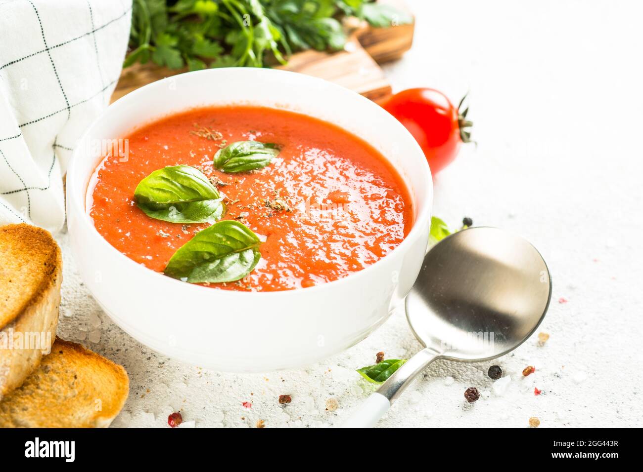 Tomato soup at white table Stock Photo - Alamy