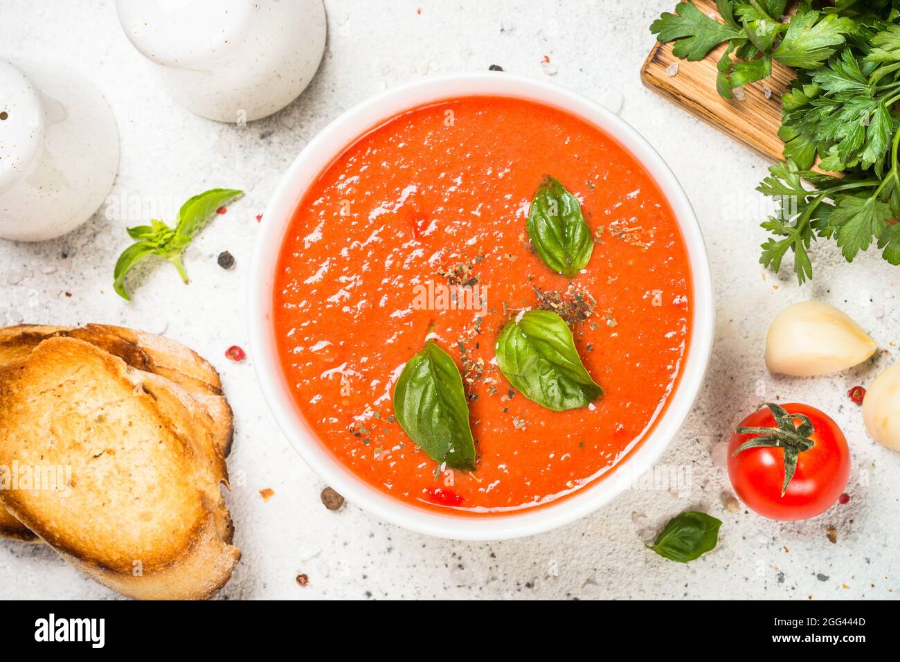 Tomato soup at white table Stock Photo - Alamy
