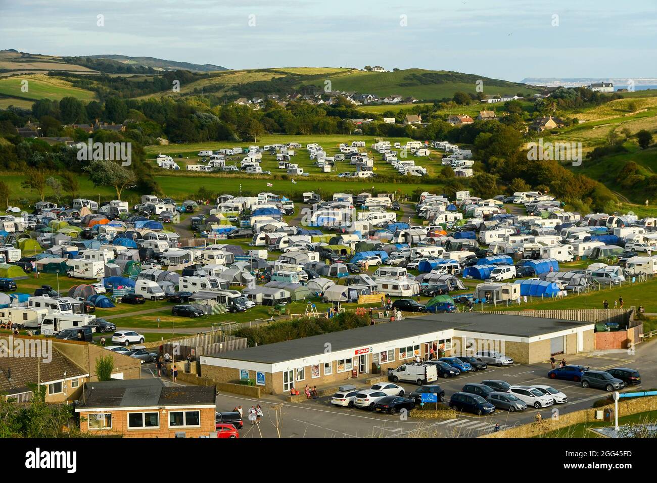 Burton Bradstock, Dorset, UK. 28th August 2021. UK Weather. The camping  field at Freshwater Beach Holiday Park at Burton Bradstock in Dorset is  packed with holidaymakers caravans, tents and camper vans on