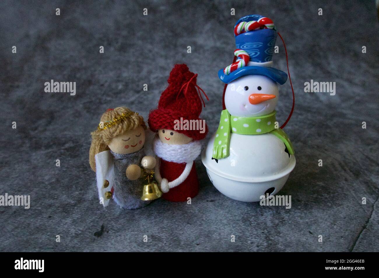 London, UK, 202108 Christmas characters with angel, snowman and chorus girl with happy faces in grey background Stock Photo