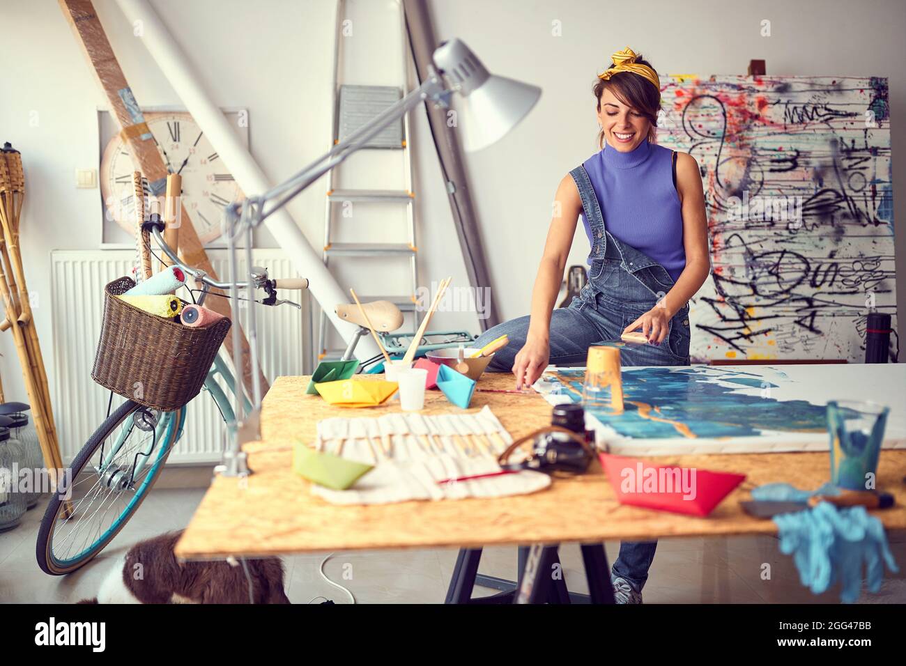 Creative female painter artist creating a piece in the studio Stock