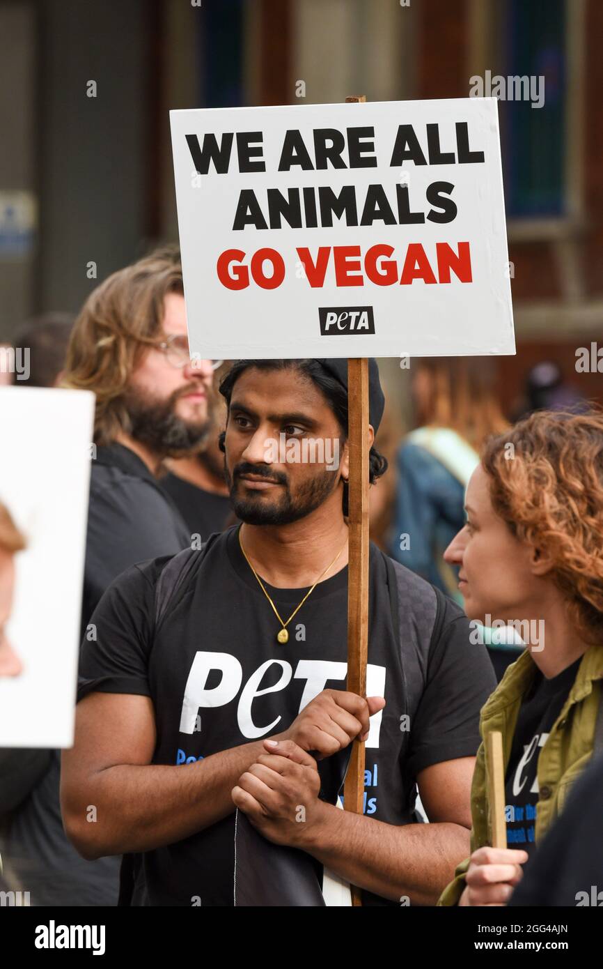 London, UK. 28th Aug, 2021. A PETA supporter hold a placard saying ‘We are all animals go vegan