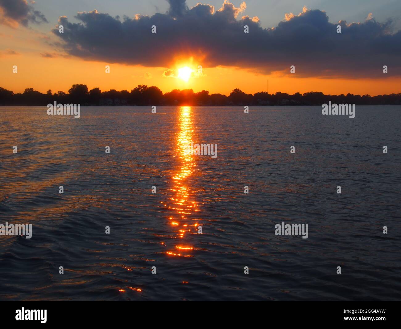 Brightly Lit Lake Lansing Sunset with Orange Reflections Stock Photo