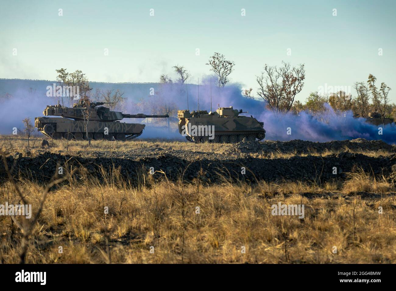 An Australian M1A1 Abrams Main Battle Tank and an M113AS4 Armoured Personnel Carrier move towards Objective Crocodile for rehearsals during Exercise Koolendong at Bradshaw Field Training Area, NT, Australia, Aug 26, 2021. U.S. Marines and Australian Army soldiers participated in mounted and dismounted attacks during the exercise. Exercises like Koolendong validate Marine Rotational Force-Darwin’s and the Australian Defence Force’s ability to conduct expeditionary advanced base operations with combined innovative capabilities; and through their shared commitment, are ready to respond to a crisi Stock Photo