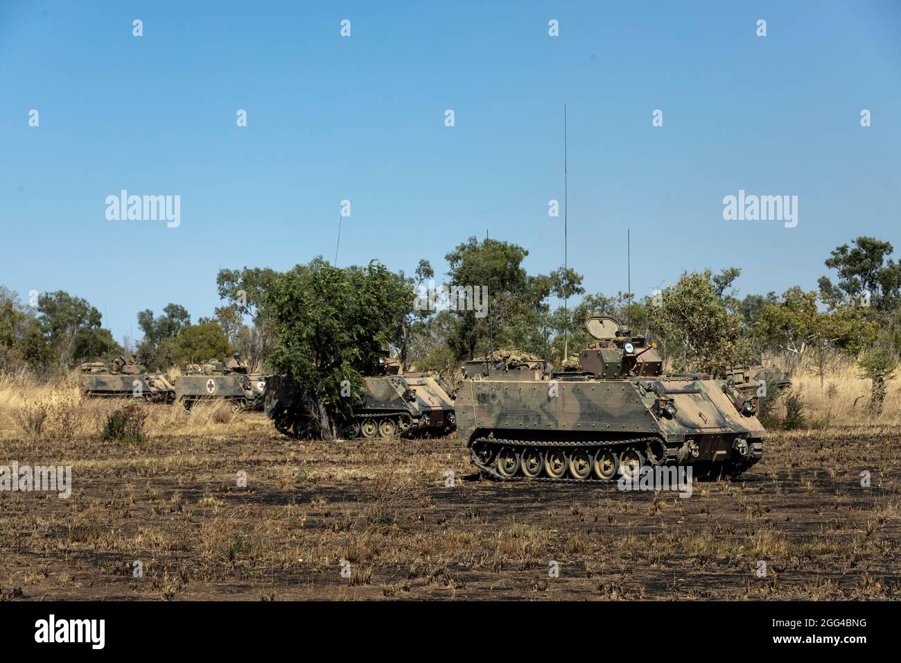 Australian M113AS4 Armoured Personnel Carriers wait for the command to move towards Objective Crocodile for rehearsals during Exercise Koolendong at Bradshaw Field Training Area, NT, Australia, Aug 26, 2021. U.S. Marines and Australian Army soldiers participated in mounted and dismounted attacks during the exercise. Exercises like Koolendong validate Marine Rotational Force-Darwin’s and the Australian Defence Force’s ability to conduct expeditionary advanced base operations with combined innovative capabilities; and through their shared commitment, are ready to respond to a crisis or contingen Stock Photo