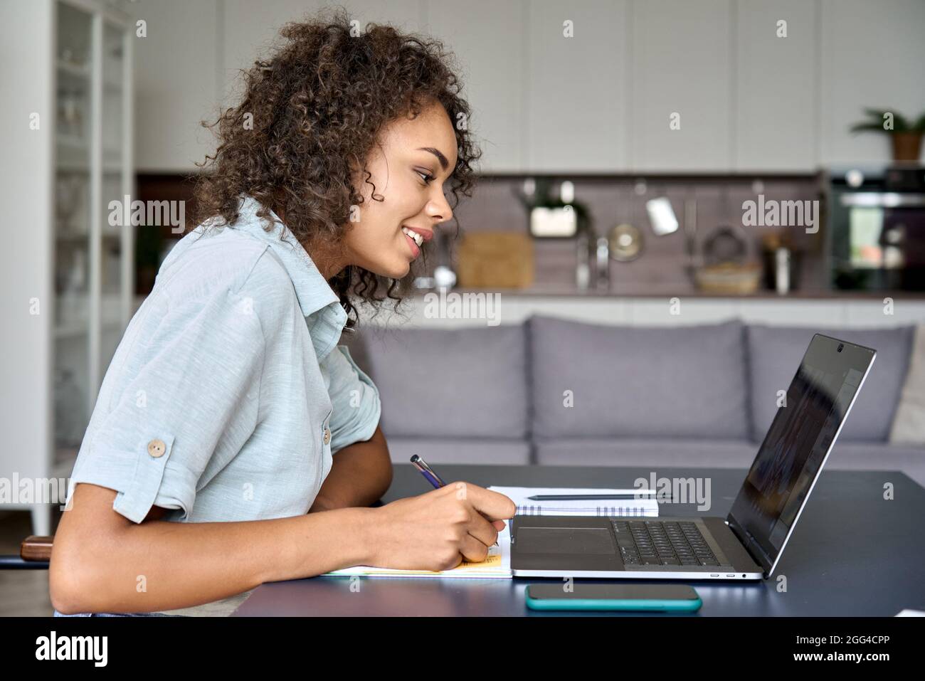 Happy African American student girl having video chat with teacher on ...