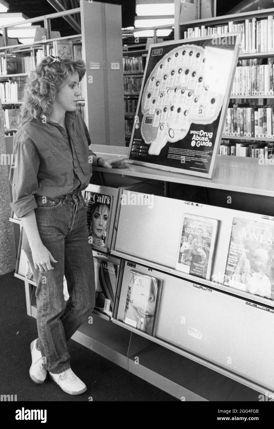 Austin Texas USA, circa 1989: Woman looking at anti-drug display at a city library. ©Bob Daemmrich Stock Photo