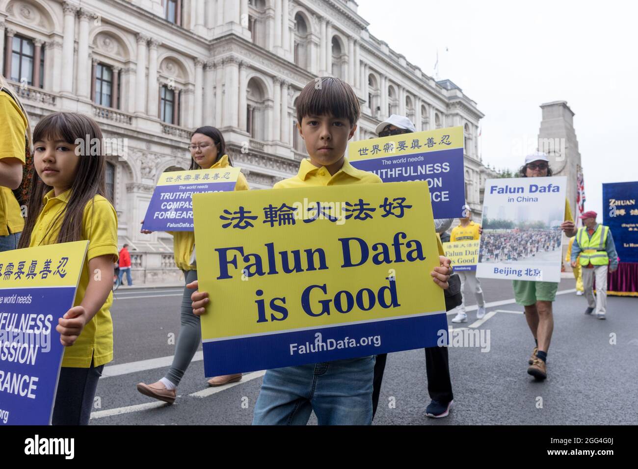 Falun gong protestor seen holding a placard that says 'falun dafa is good', during the demonstration.Falun Gong is a global organisation that opposes the Chinese Communist Party (CCP) in form of spiritual practice. The organisation strives to unveil corruption and human rights violation undertaken by the CCP and adopts the doctrine of ‘truthfulness, compassion, and forbearance'. Several Falun Gong members gathered in London to march across Westminster, bringing across messages including stop organ harvesting and political persecution in China. (Photo by Belinda Jiao/SOPA Images/Sipa USA) Stock Photo