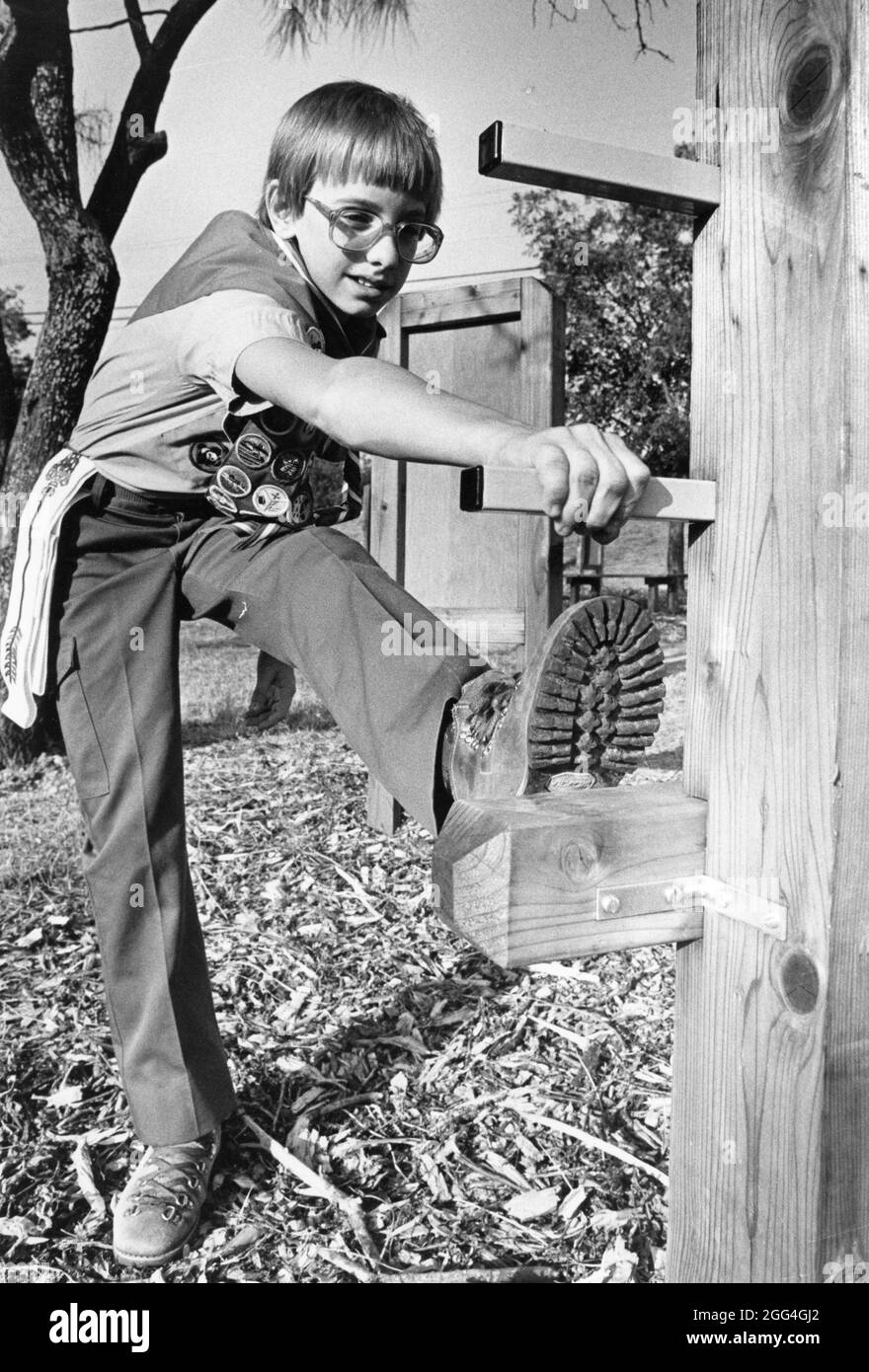 © 1985 Eagle Scout stretches on exercise equipment designed by himself for an Eagle Scout project. Stock Photo