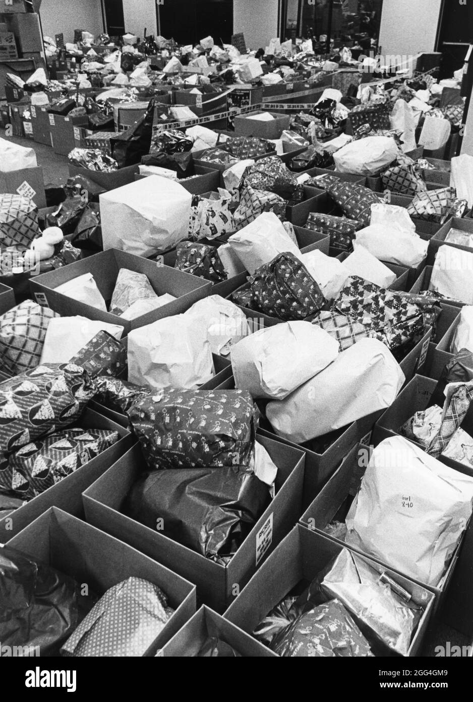 Austin Texas USA, 1992: Hundreds of children's Christmas gits, collected and wrapped by a nonprofit organization, await delivery to low-income families by the group's volunteers. ©Bob Daemmrich Stock Photo