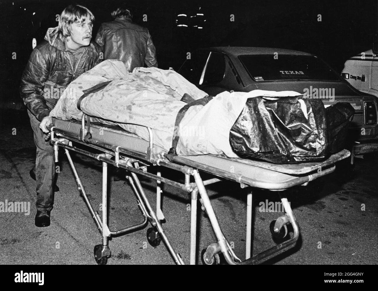 Austin Texas USA, 1984: Technician from medical examiner's office takes deceased accident victim to van to transport to forensic lab. ©Bob Daemmrich Stock Photo