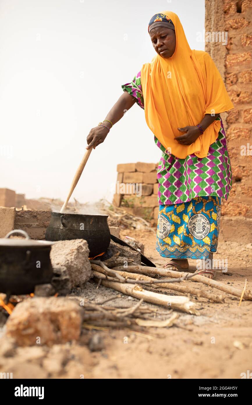 An African Woman Displaced By Conflict Burkina Faso Cooks Over A Pot
