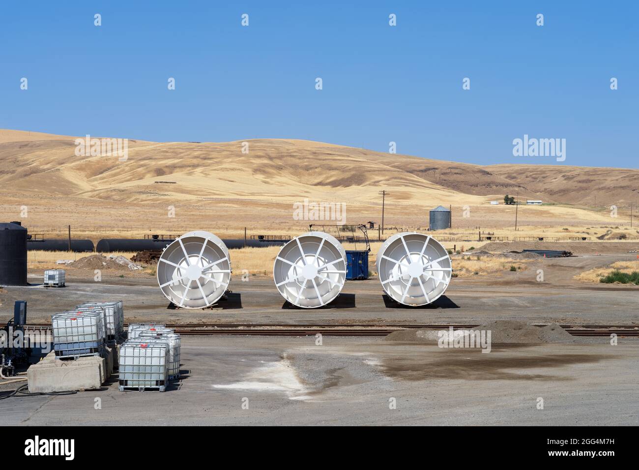 Large storage bins lying on their sides by the railroad tracks Stock Photo Alamy
