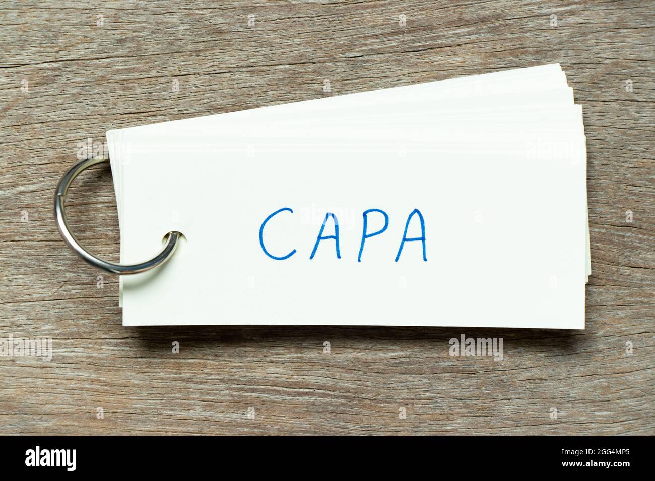 Flash card with handwriting word CAPA (abbreviation of corrective action and preventive action) on wood background Stock Photo
