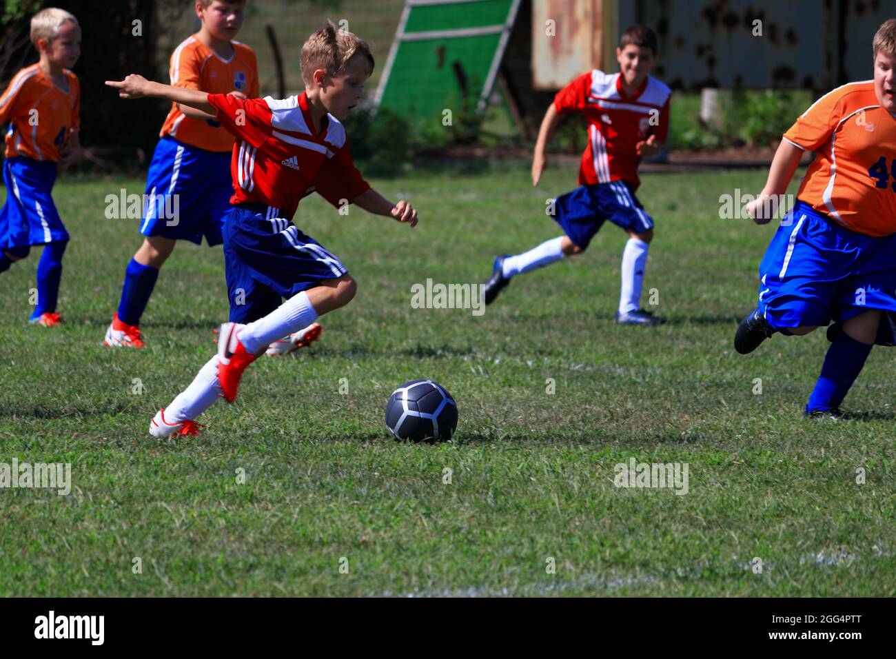 Advancing the ball down the field during an outdoor youth soccer game Stock Photo