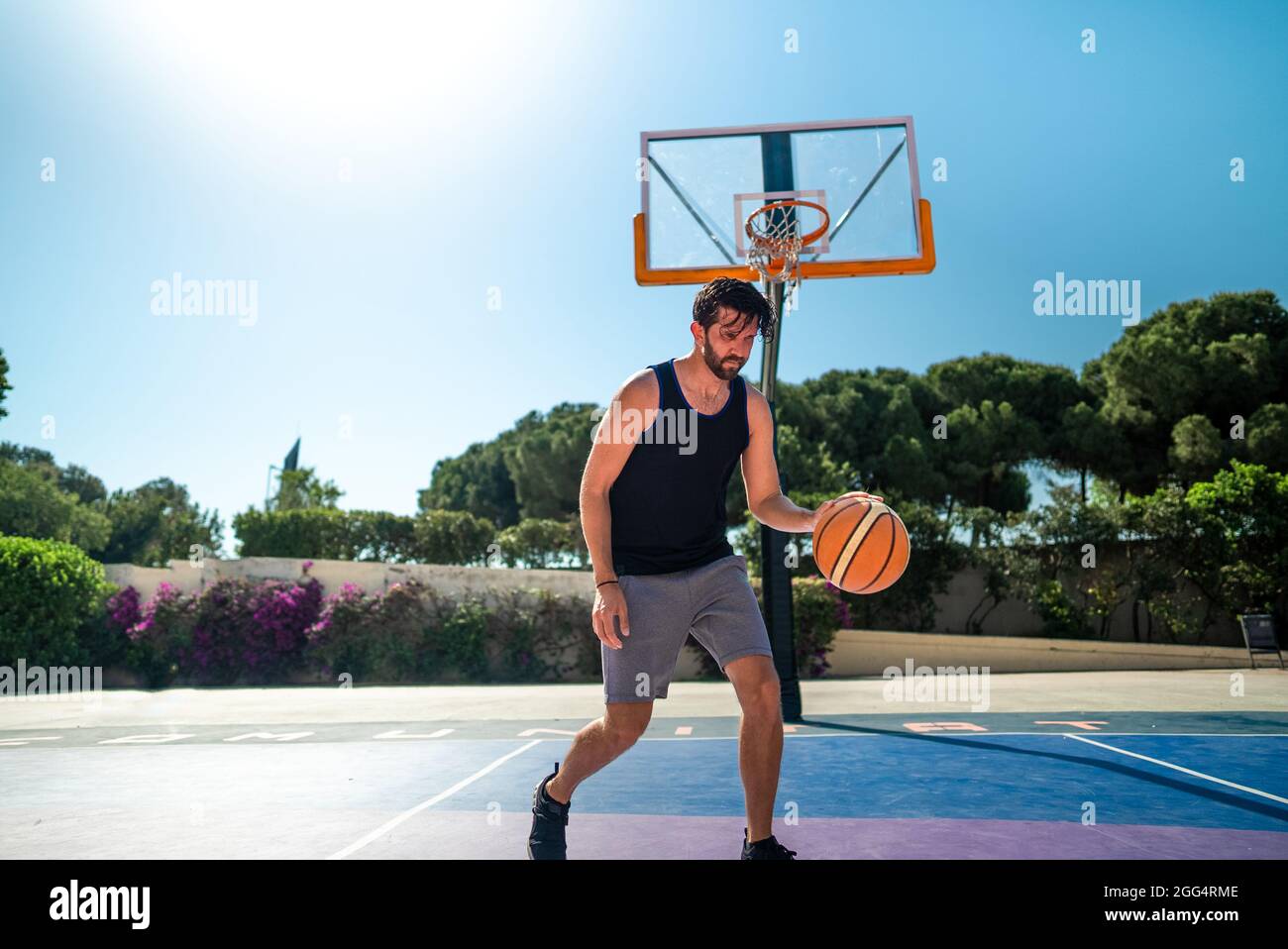 basketball player runs across the basketball field in training. Summer