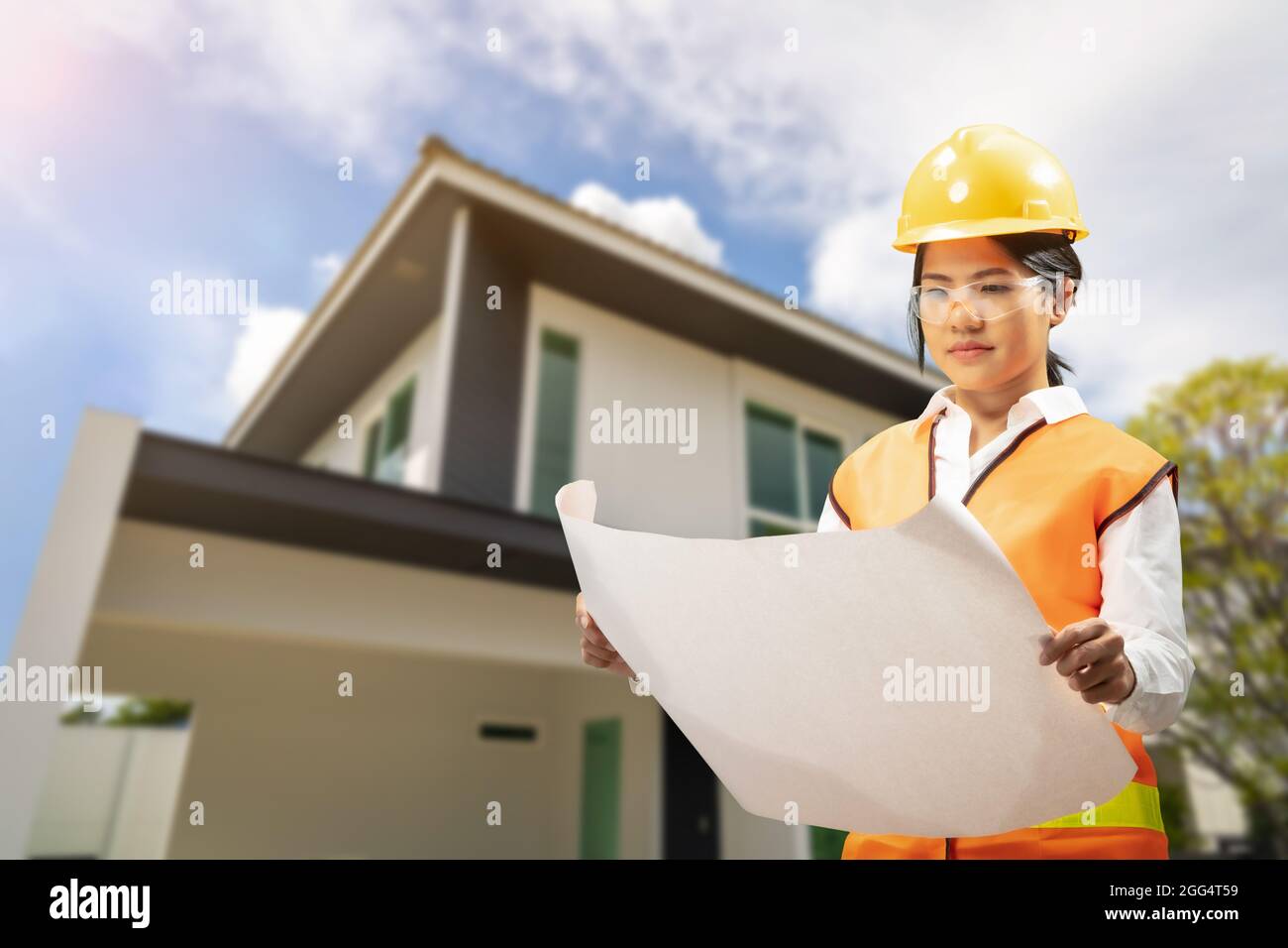 Engineer or architect with blueprint for house building Stock Photo