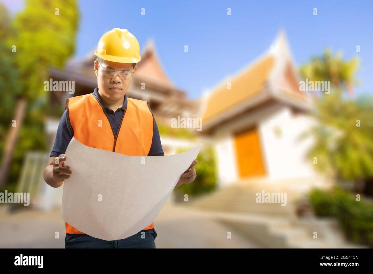 Engineer or architect with blueprint for house building Stock Photo