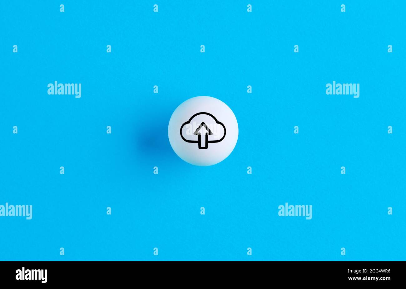 Upload symbol on a ball button on blue background. Stock Photo