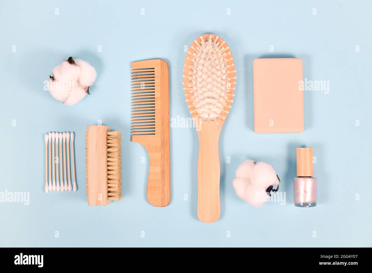 Eco friendly wooden beauty and hygiene products like comb and soap on blue background Stock Photo