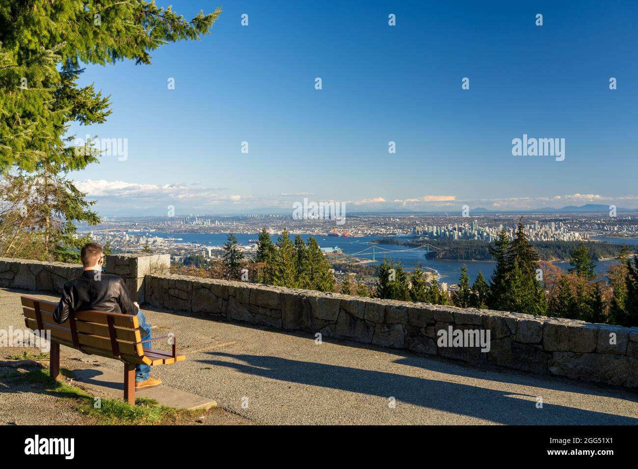 Tourists relaxing in the Cypress Mountain Vancouver Outlook. Vancouver city downtown and Harbour panorama view. Lions Gate Bridge, BC, Canada. Stock Photo