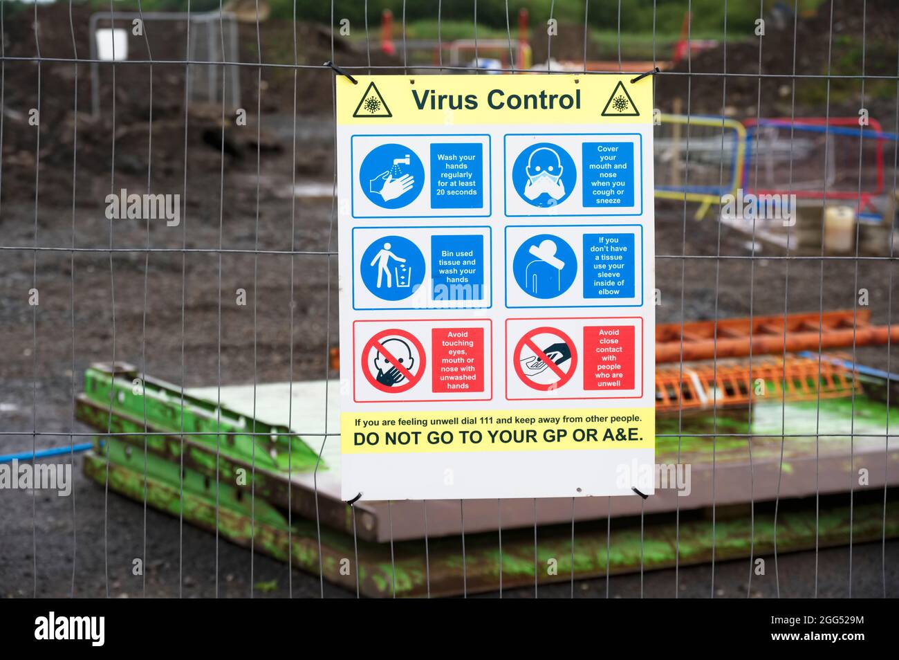 Construction site health and safety message rules sign board signage on fence boundary Stock