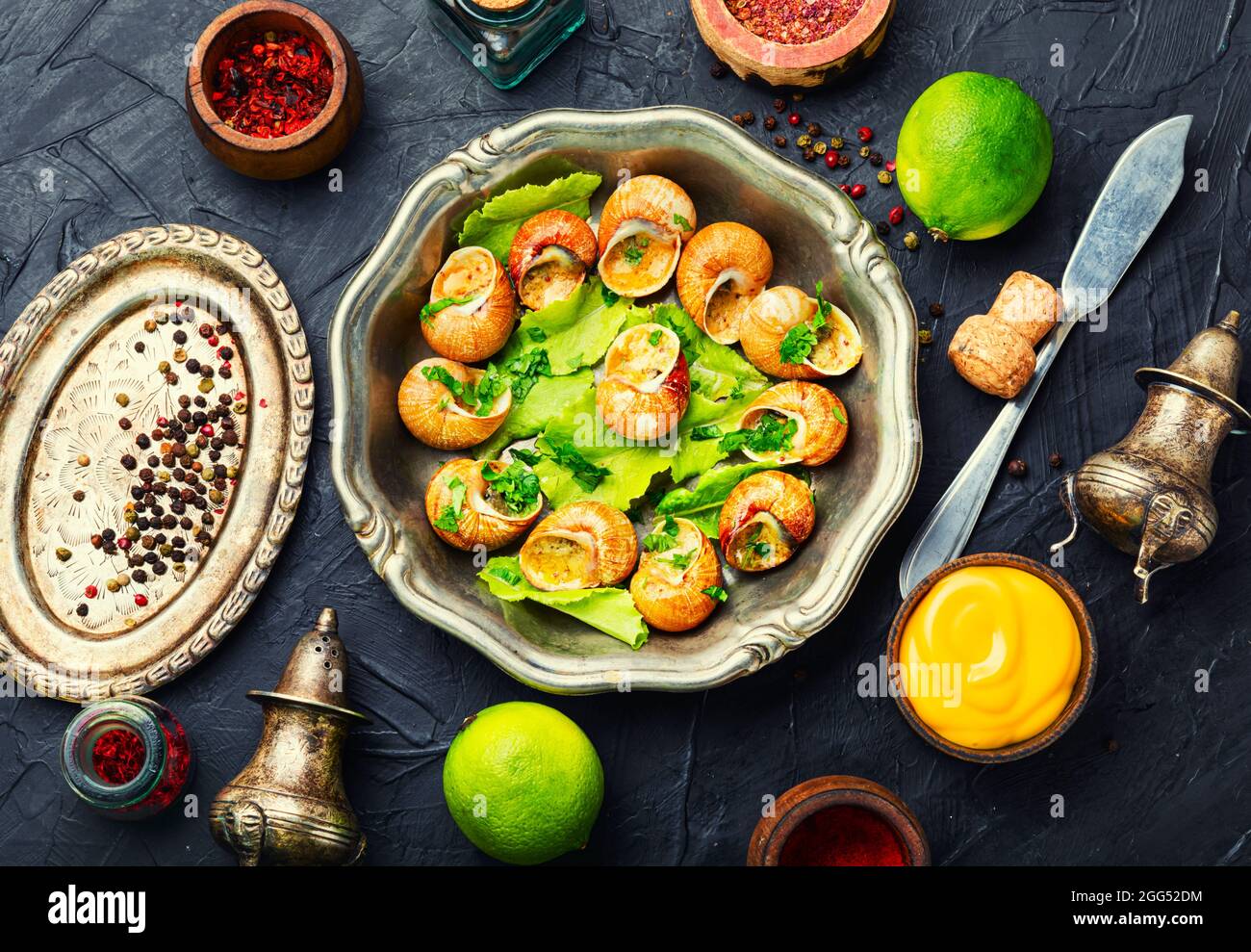 Edible snails stuffed with green butter, French delicacies Stock Photo