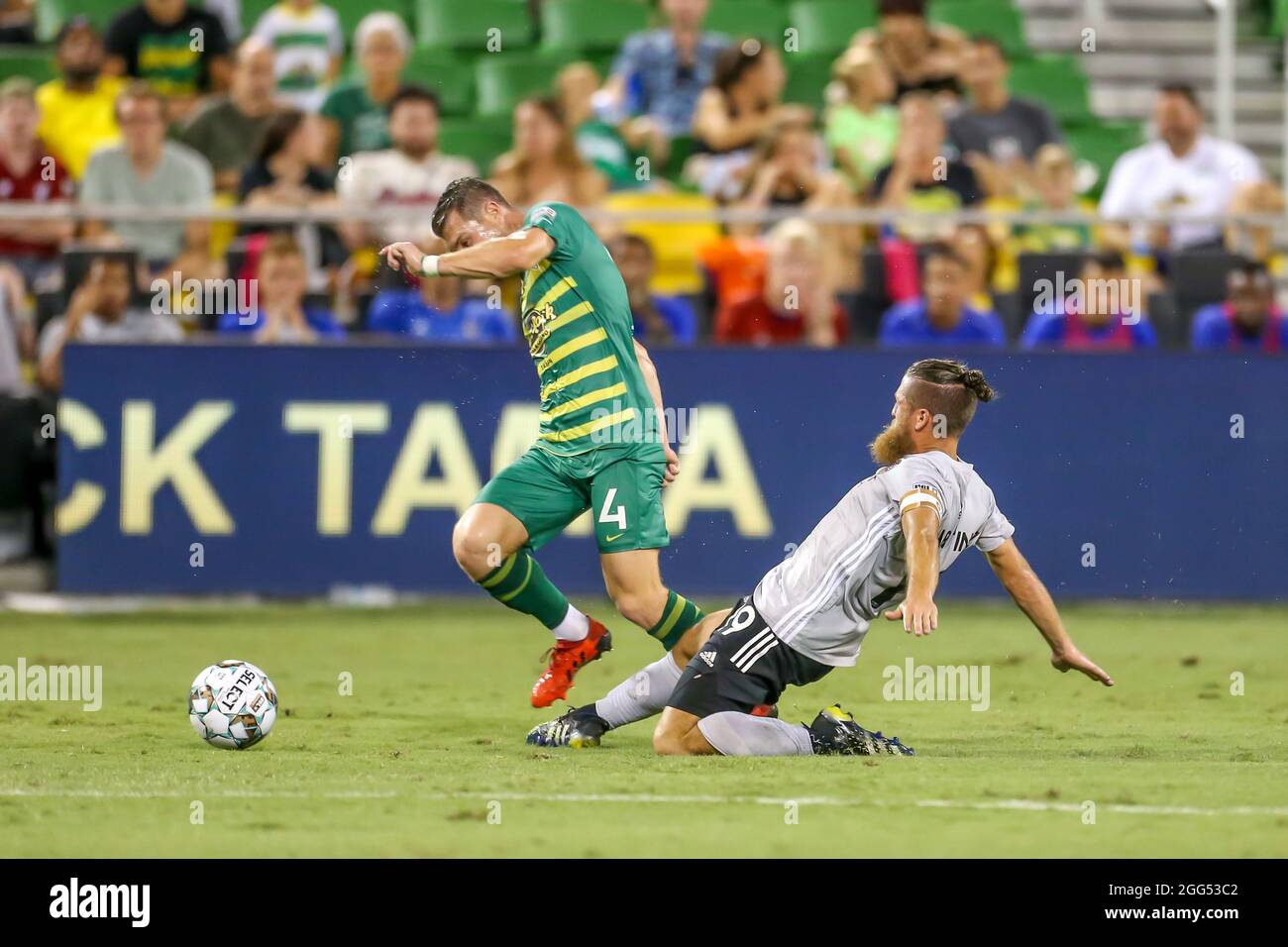 St. Petersburg, FL USA;  Charlotte Independence goalkeeper Austin Pack (1) slide tackles and trips up Tampa Bay Rowdies midfielder Lewis Hilton (4) du Stock Photo