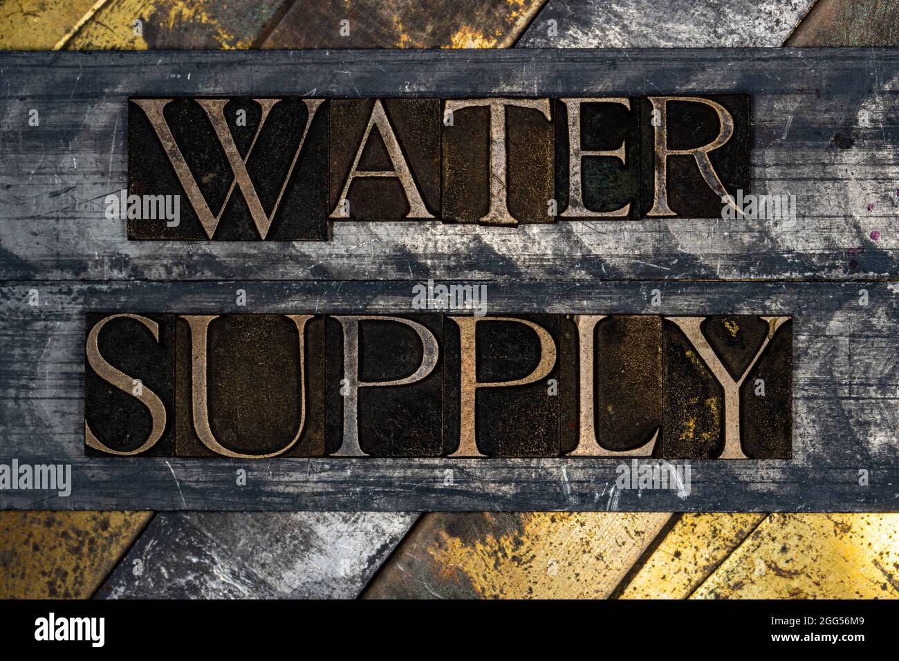 Water Supply text message on vintage textured grunge copper and gold background Stock Photo