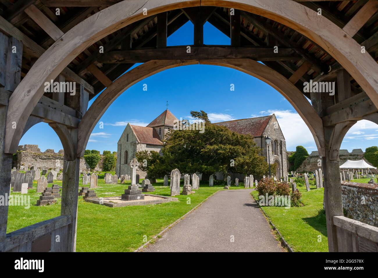 The 12th century Norman church of St Mary, within Portchester Castle's outer bailey, seen through the lychgate: Portchester, Hampshire, UK Stock Photo