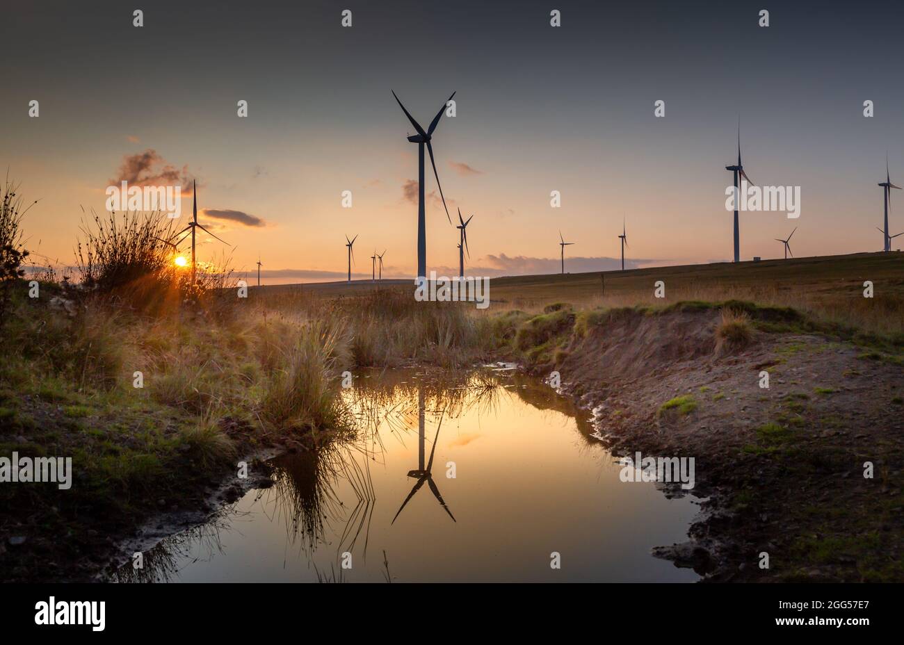 Sunset at Mynydd y Betws Wind Farm on the common land to the east of Ammanford in Carmarthenshire, Wales, UK Stock Photo