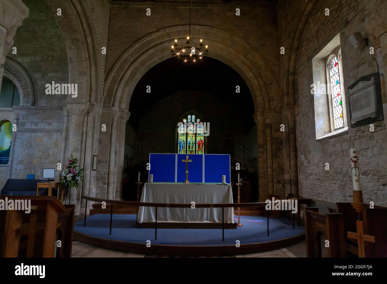Interior of the 12th century Norman church of St Mary, within Portchester Castle, Portchester, Hampshire, UK: altar and reredos Stock Photo