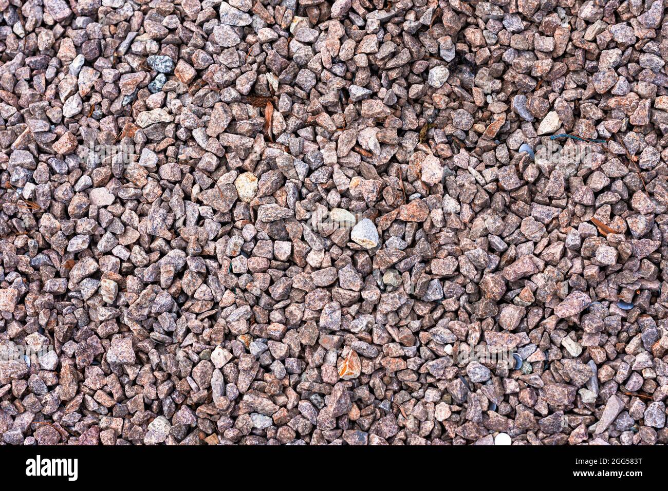 Background structure of reddish grey pebbles with sharp edges for garden and path design Stock Photo