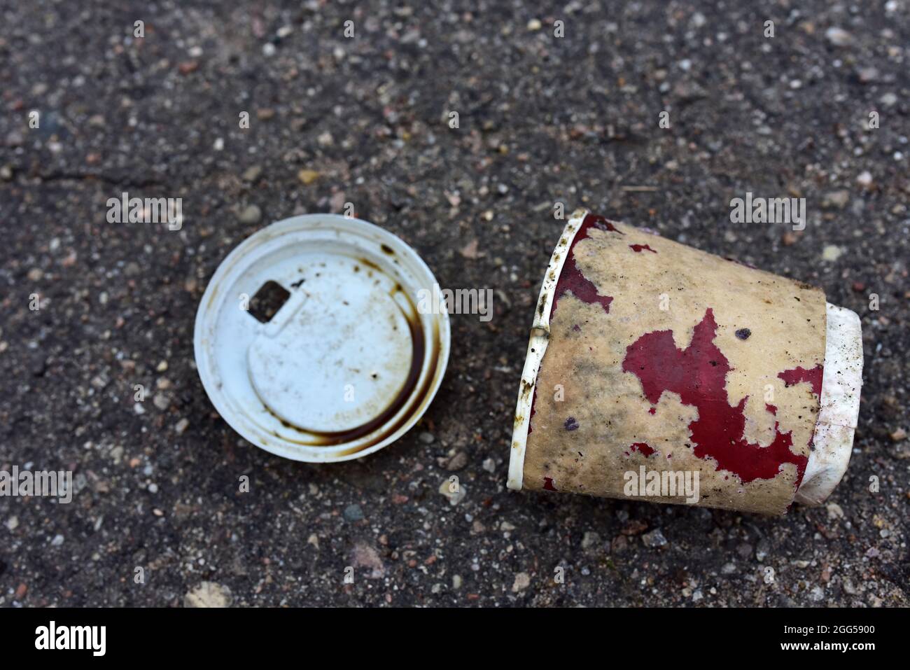 Crumpled a paper coffee cup on asphalt. Discarded disposable coffee cup ...