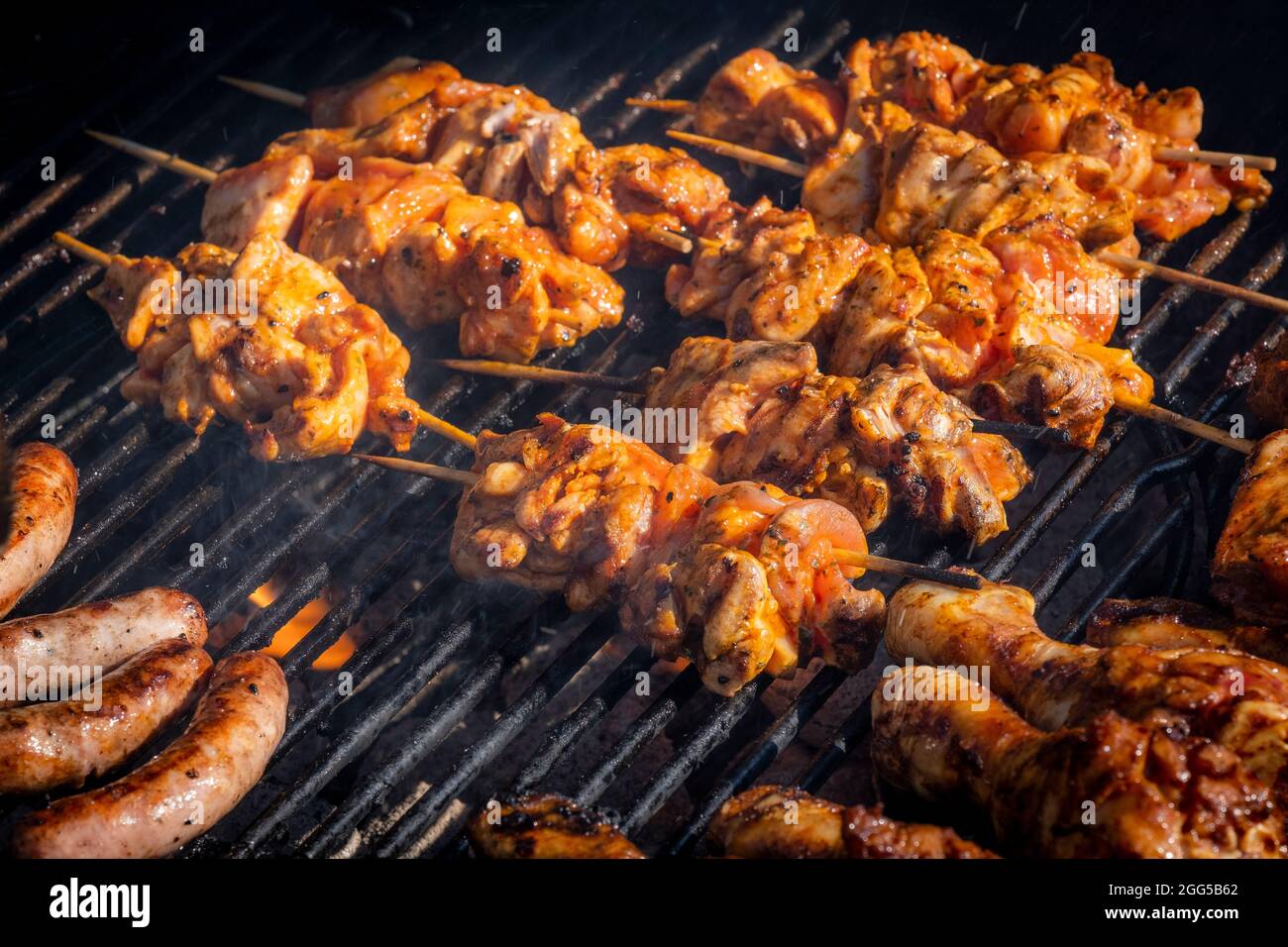 Chicken Kebabs cooking on a barbeque. Stock Photo