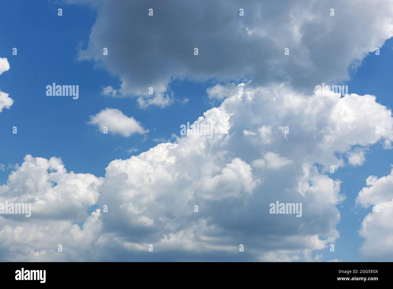 Beautiful blue sky with puffy cumulus clouds background. Stock Photo