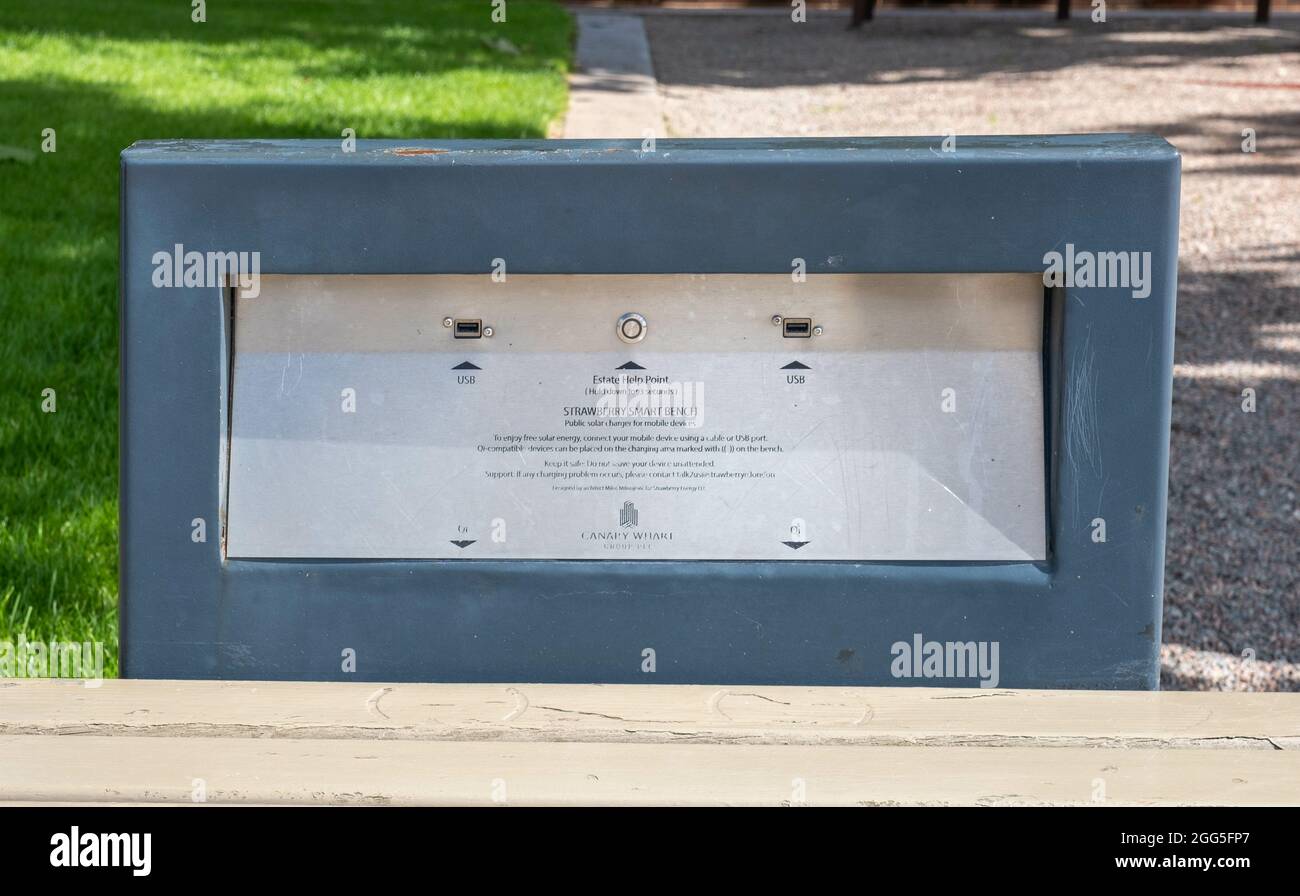 LONDON, UNITED KINGDOM - Aug 10, 2021: The controls of a solar-powered smart bench with phone charging points in Canary Wharf, London, UK Stock Photo