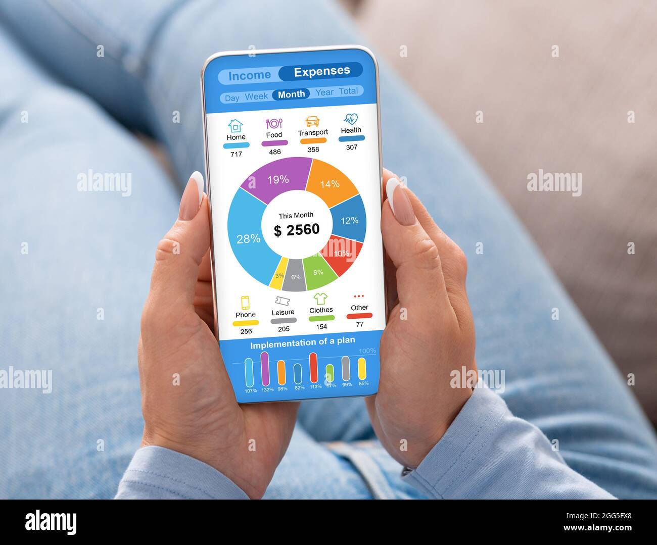 Female hands using cellphone, checking monthly family expenses Stock