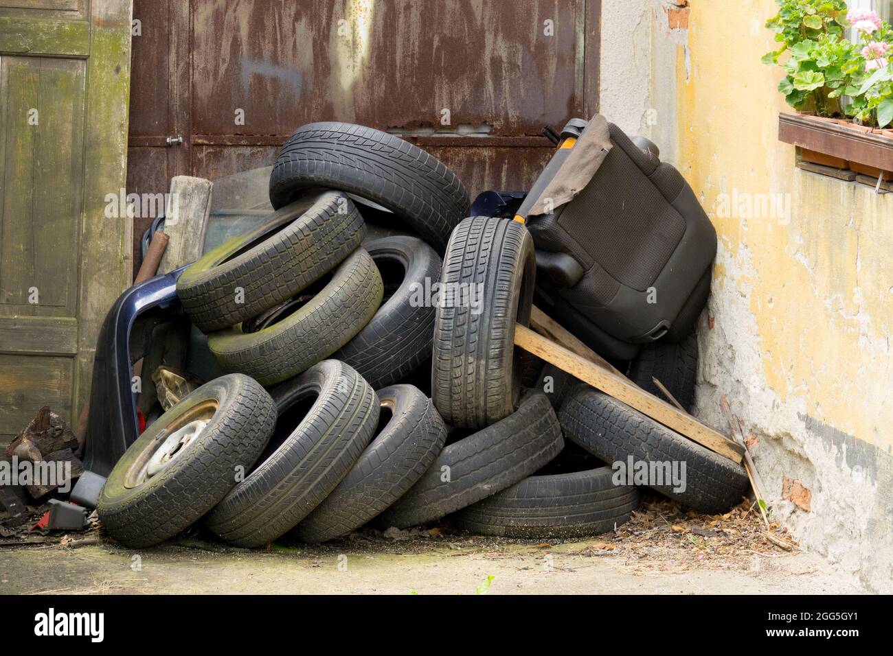 Discarded used, old rubber tires at the house door Stock Photo