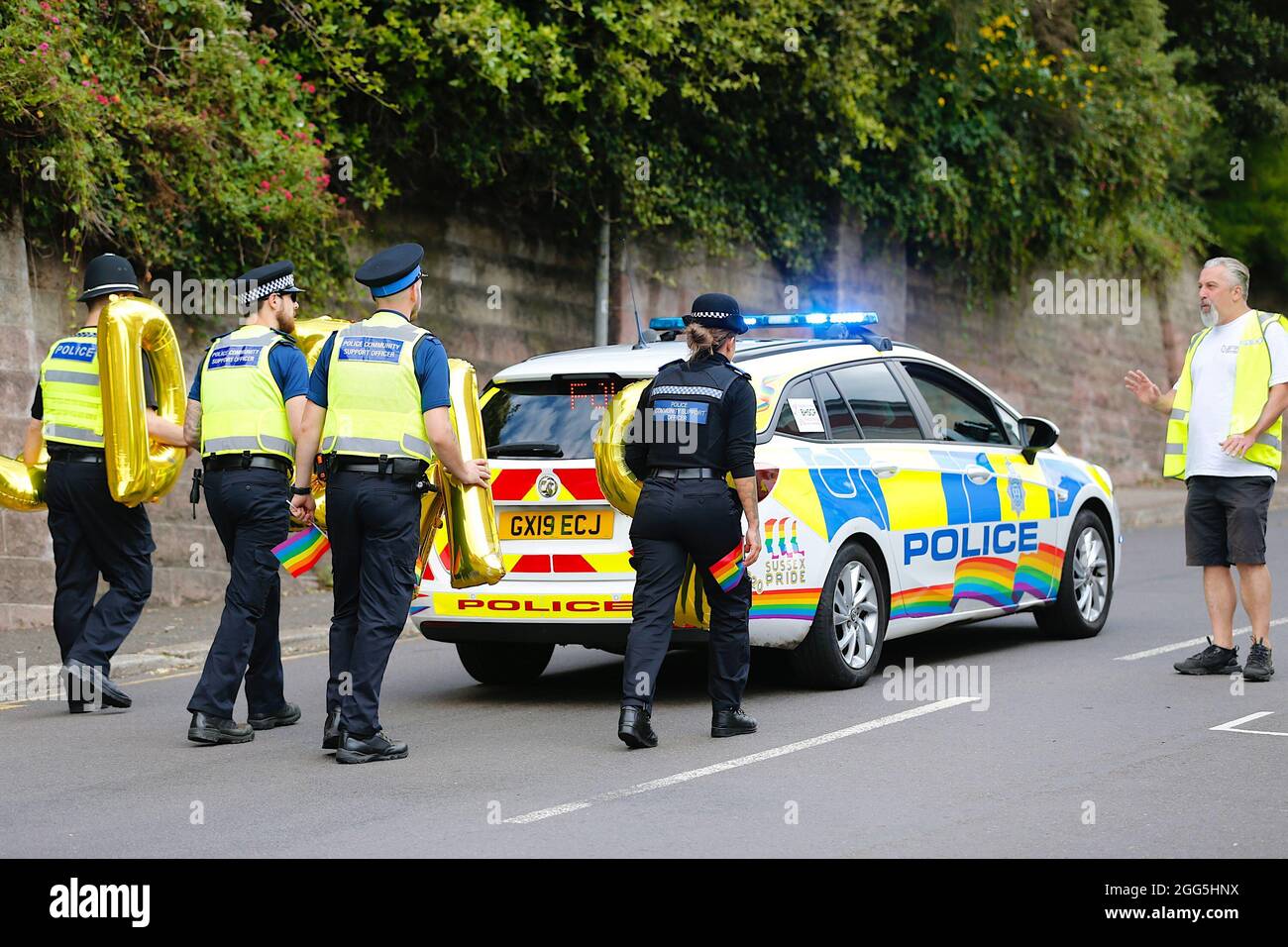 Hastings, East Sussex, UK. 29 August, 2021. The Pride parade 2021 returns to the seaside town of Hastings in East Sussex on the Bank holiday Sunday with the theme of Back to to the 80’s. Police heads up the pride procession with gay pride colours displayed on the police car. Photo Credit: Paul Lawrenson /Alamy Live News Stock Photo