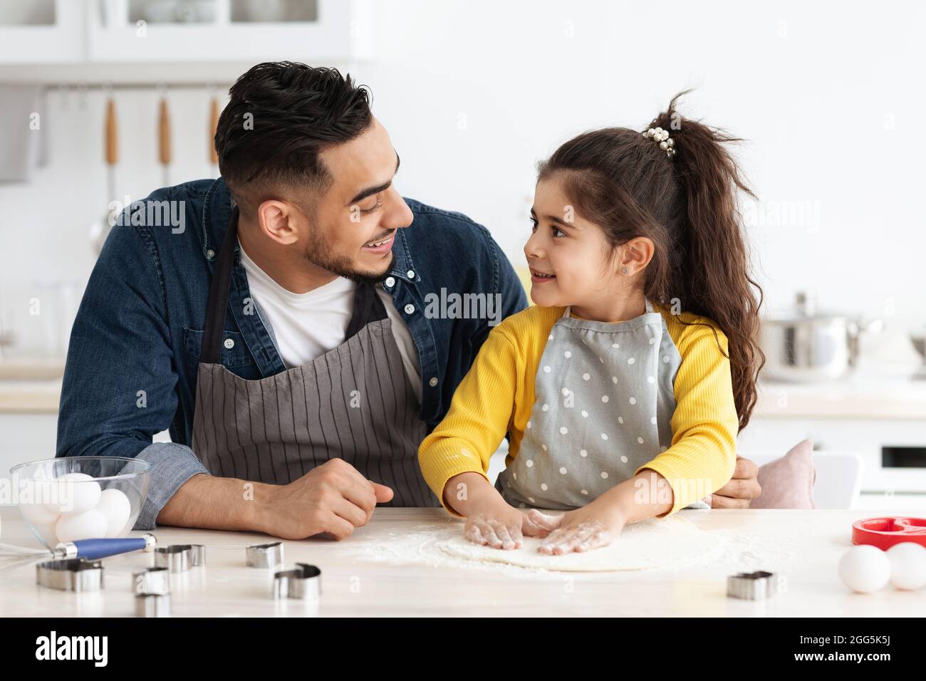 Cute Little Arab Girl Baking In Kitchen With Her Dad Stock Photo
