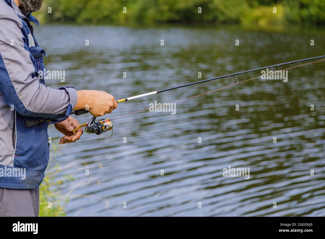Hand holding fishing pole hi-res stock photography and images - Alamy