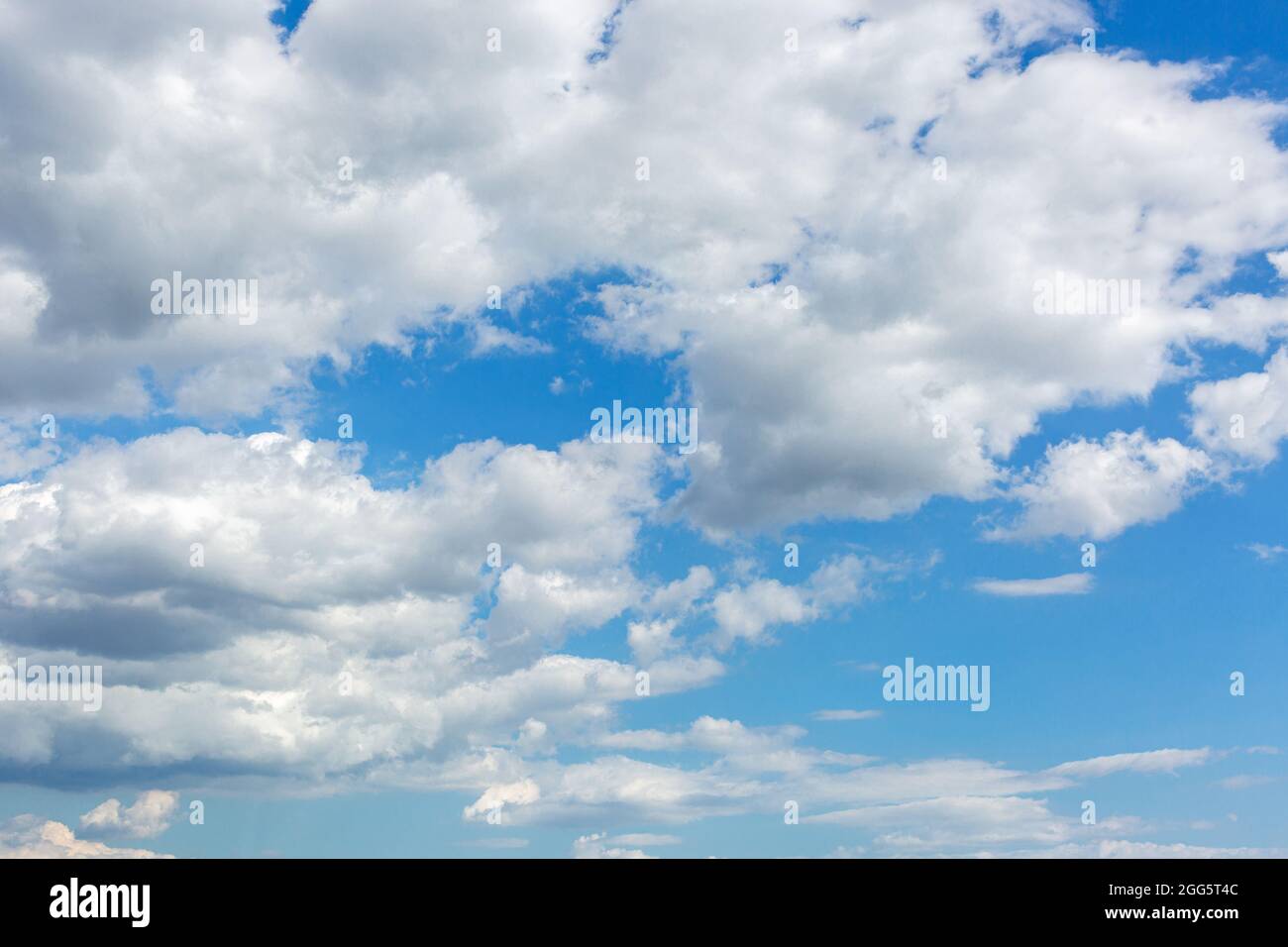 Beautiful blue sky background with puffy cumulus and cirrus clouds. Stock Photo