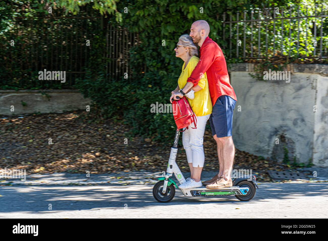 ROME ITALY, UK. 29th Aug, 2021. A man and woman riding together in Villa  Borghese on a Lime electric scooter on a hot day in Rome. Electric scooters  have become popular in