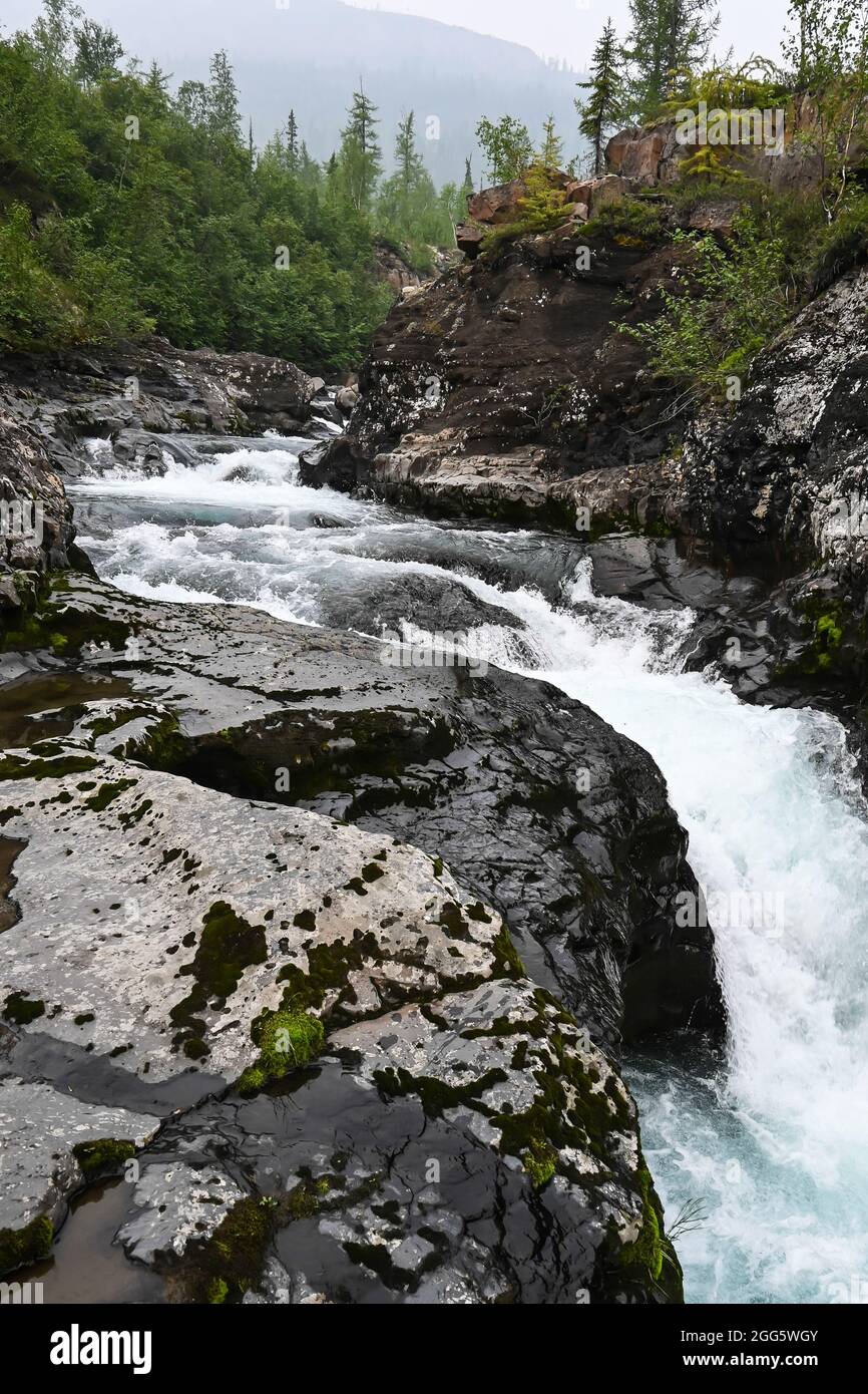 Putorana Plateau, a waterfall on the Grayling Stream. Mountain stream on a  cloudy day Stock Photo - Alamy