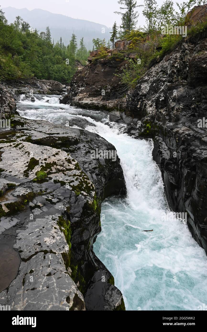 Putorana Plateau, a waterfall on the Grayling Stream. Mountain stream on a  cloudy day Stock Photo - Alamy