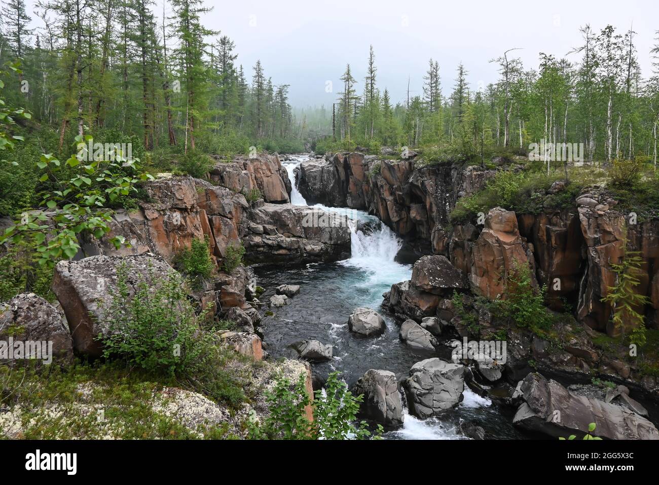 Putorana Plateau, a waterfall on the Grayling Stream. Mountain stream on a  cloudy day Stock Photo - Alamy